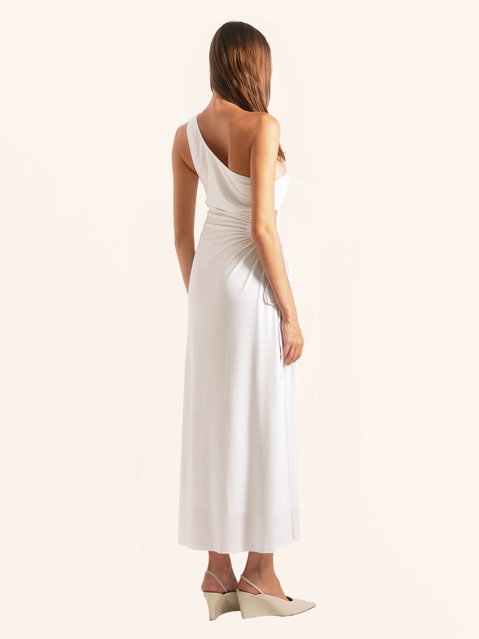 Back side angle of white one shoulder midi dress with draped style