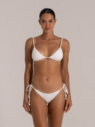 Woman smiling in white ribbed string bikini set with adjustable triangle top, front view