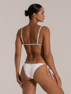 Back view of white textured bikini top with adjustable shoulder straps and back tie