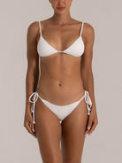 Front view of a white textured bikini bottom with side ties.