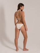Angled back view of white triangle bikini with halter and back tie