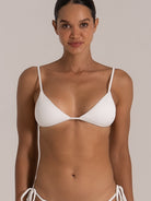 Front close-up of white triangle bikini top featuring ribbed fabric and minimal coverage
