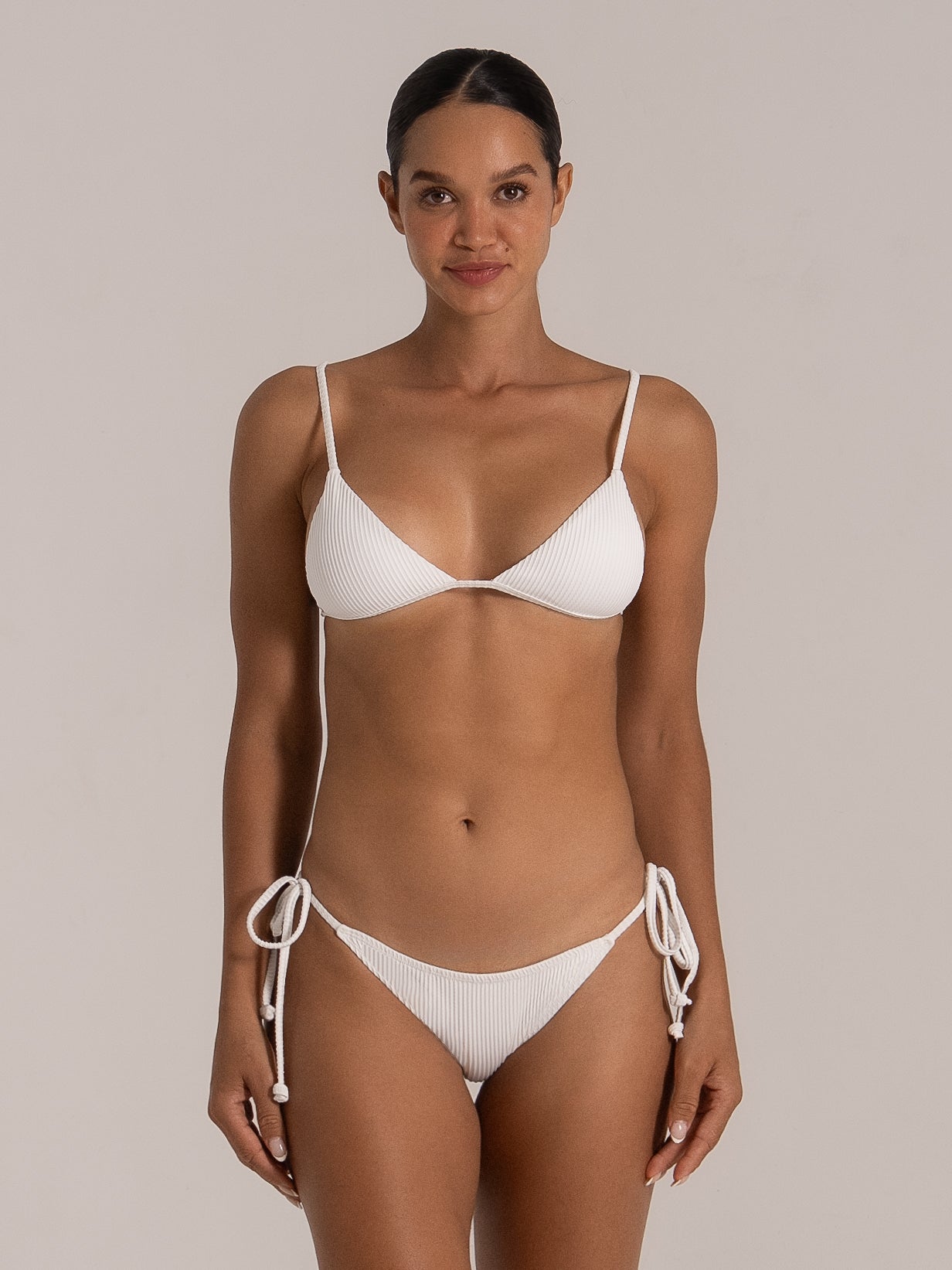 Full front view of white textured triangle bikini top with spaghetti straps
