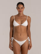 Full front view of white textured triangle bikini top with spaghetti straps