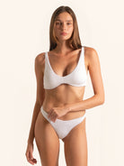 Front view of white wireless bikini top with wide straps and scoop neckline.