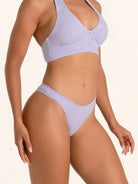 Women’s lilac swim bikini bottom featuring stylish cutout design.