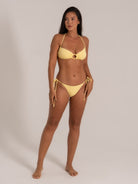 Yellow ring bikini set with halter neck and cheeky bottom, side view