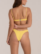 Rear view of yellow bikini bottom with cheeky coverage and structured waistband