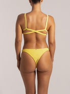 Back view of a high leg yellow textured bikini bottom with wide side bands
