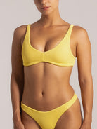 Close-up of yellow textured bikini with underwire top and high-leg bottom.