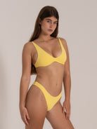 Side view of yellow bikini top with deep V-cut front and wide-set shoulder straps